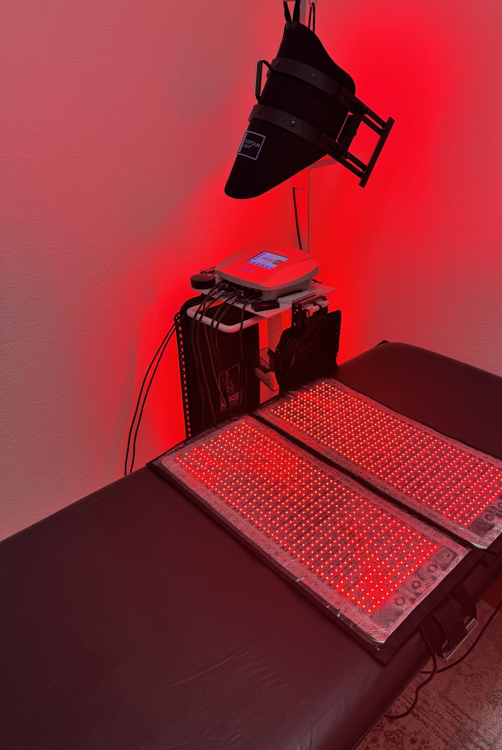 Contour Light red light device and pads ready on a treatment bed at Genesis Red Light, Cedar Park