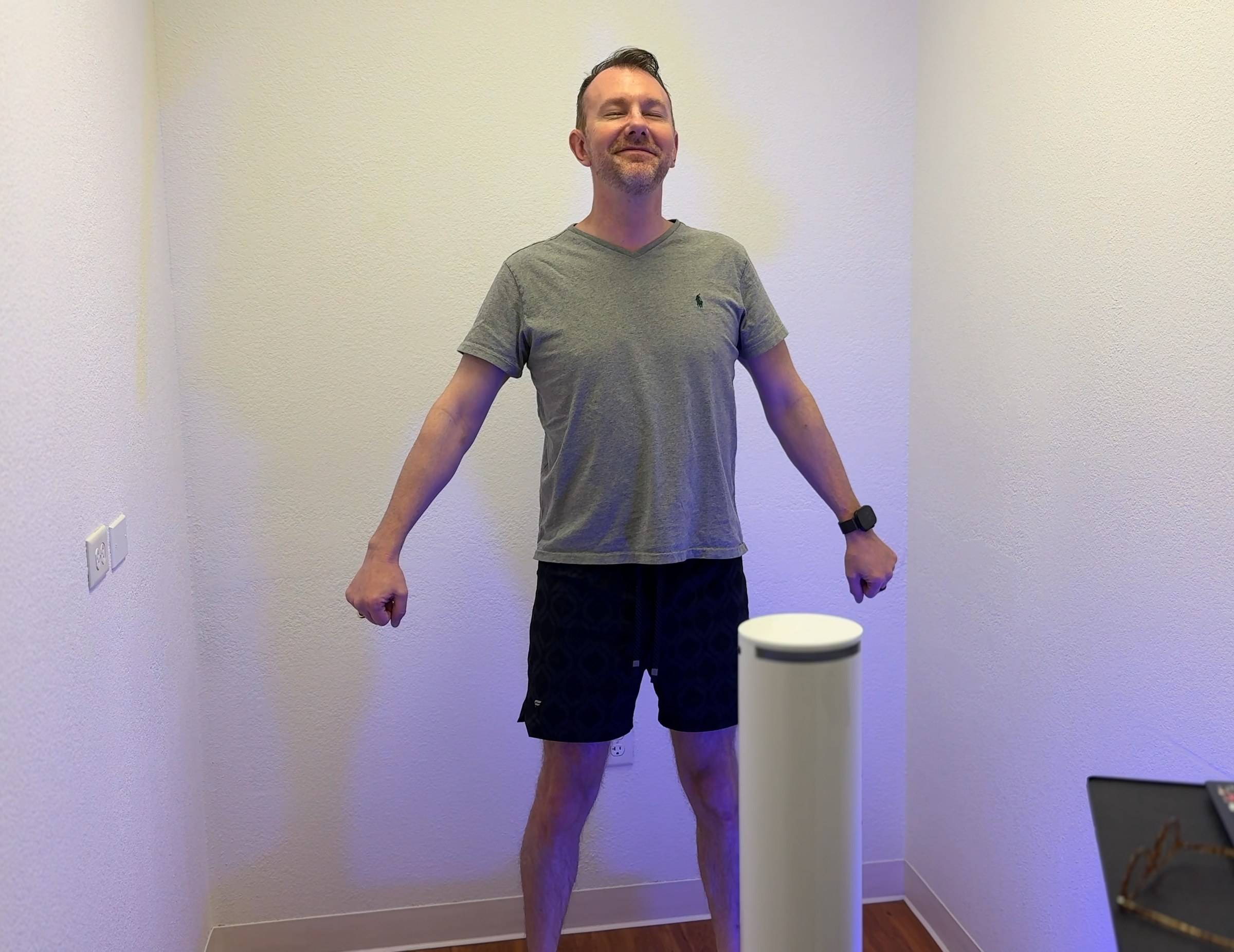 John, Clinic Manager, standing on the Styku 3D body scanner at Genesis Red Light in Cedar Park, TX